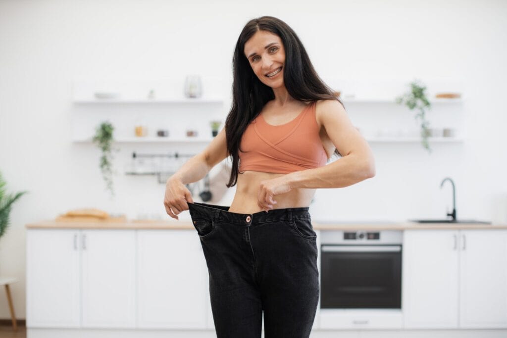 Woman showing that she dropped pounds